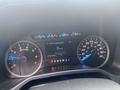 A close-up view of the dashboard of a 2015 Ford F-150 displaying a digital speedometer and analog gauges for speed and RPM