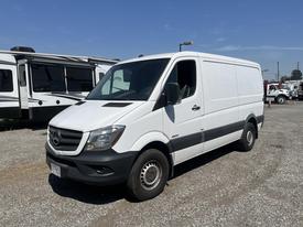 A white 2016 Mercedes-Benz Sprinter van with a boxy design and front grille featuring the Mercedes star logo