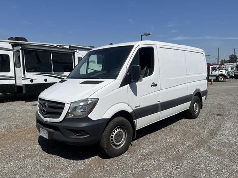 A white 2016 Mercedes-Benz Sprinter van with a boxy design and front grille featuring the Mercedes star logo