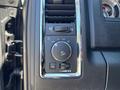 Control panel with various knobs and buttons for lights and settings in a 2015 RAM 1500