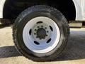 Close-up of a white wheel and tire on a 2024 Ford F-550 showcasing a rugged design and deep treads for enhanced traction