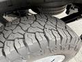 Close-up of a rugged tire tread on a vehicle showing deep grooves and patterns designed for traction and durability