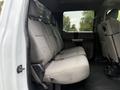Interior view of a 2019 Ford F-350 SD showing the rear seating area with gray cloth seats and a spacious layout