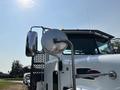 A 2020 Peterbilt 330 truck with a shiny side mirror and prominent front grille