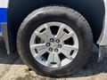 A close-up of a silver alloy wheel from a 2017 Chevrolet Colorado with a rugged tire labeled BFGoodrich All-Terrain T/A