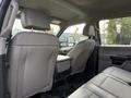 Interior view of the back seats of a 2020 Ford F-550 featuring gray leather upholstery and a center console