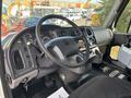 Interior view of a 2013 Freightliner 114SD truck featuring a steering wheel dashboard with gauges controls and pedals
