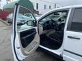 A 2014 RAM Cargo Van with an open driver's door showcasing the interior including the dashboard and seating
