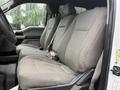 Front seats of a 2019 Ford F-350 SD featuring gray fabric upholstery with a textured design and seatbelts attached