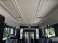 Interior view of a 2016 RAM Promaster showing the ceiling with lights and seats with patterned fabric