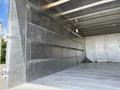 The interior of a 2020 Chevrolet Silverado truck bed features smooth metallic surfaces with vertical grooves and no visible cargo