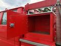 A red 2001 Toyota Dyna truck with an open storage compartment and a silver handle on the side