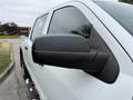 A close-up view of the side mirror of a 2016 GMC Sierra 1500 showcasing its black housing and angled position