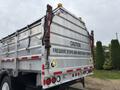 A 2017 Autocar Xpert truck with a silver metallic body featuring a warning sign that reads CAUTION FREQUENT STOPS AND WIDE RIGHT TURNS on the back