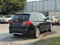 A black 2013 BMW X3 parked with its rear visible showcasing its sleek design and alloy wheels