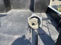 A metal lever with an UP and DOWN label, attached to a sturdy pole, designed for adjusting height on a 2006 Sterling Acterra vehicle