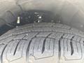 Close-up of a tire and wheel assembly from a 2017 Chevrolet Colorado showing tread pattern and suspension components