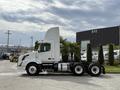 A 2012 Volvo VNL truck in white with a tall cab and large sleeper compartment visible from the side