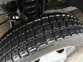 Close-up of a wet tire and wheel assembly of a 2015 Ford F-450 showcasing the tread pattern and details of the wheel
