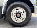 Close-up of a 2016 Ford F-750 wheel featuring a black tire with a white rim and multiple lug nuts in the center