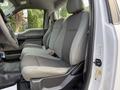 Front seats of a 2018 Ford F-150 featuring a combination of gray cloth and vinyl upholstery designed for comfort and utility