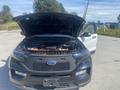 A 2020 Ford Explorer with its hood open displaying the engine compartment and front grille