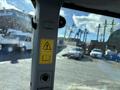 A 2010 New Holland T4050 tractor viewed from inside the cab showcasing its steering column and dashboard controls