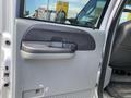 The interior door panel of a 2007 Ford F-350 SD showing the handle and speaker area