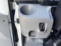 A close-up of a cup holder with an adjustable temperature control knob mounted on a vehicle interior panel