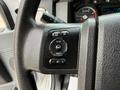 A close-up view of the steering wheel controls of a 2019 Ford F-750 featuring buttons for information reset setup and various functions