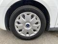 A silver wheel with a blue Ford logo mounted on a Michelin tire designed for a 2017 Ford Transit Connect