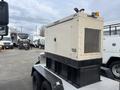 A 2005 Katolight SED60FPJ4 generator mounted on a trailer with a beige exterior and a black base