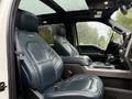 Interior of a 2018 Ford F-150 featuring leather front seats with a modern design and a central console between them