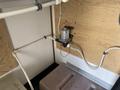 A 2008 Wells Industries Inc EW1422 pump mounted on a wall with connected pipes and a wiring harness