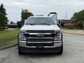 A white 2020 Ford F-550 with a shiny chrome grille and prominent headlights facing forward