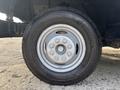 A close-up view of a wheel and tire from a 2018 Ford Econoline showing the metal rim and tire tread details