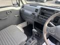 Interior view of a 2010 Daihatsu Hijet showing the driver's seat dashboard gear shift and radio controls