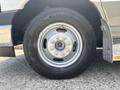 A close-up view of a silver wheel on a 2020 Chevrolet Express featuring a Goodyear tire with distinct tread patterns and a circular hubcap design