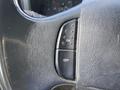 Close-up of the steering wheel controls of a 2007 Ford F-350 SD showing an ON button and an OFF button