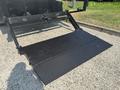 A black ramp on a truck with a textured surface extending outwards for loading or unloading purposes