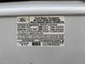 A label from a Ford Econoline van displaying important engine information and vehicle emission control details for the 2008 model