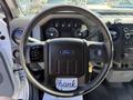 Close-up of the steering wheel and dashboard of a 2014 Ford F-250 SD with various controls and gauges visible