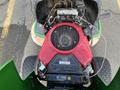 Close-up view of the engine of a 2021 John Deere L Series S lawn mower with a red engine cover and visible electrical components