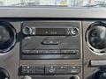 The image shows the dashboard of a 2018 Ford F-750 with a stereo system and climate control buttons visible