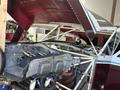 A 1986 Sorrell Hiperbipe SNS-7 amateur-built aircraft with an open engine compartment revealing the engine and internal components