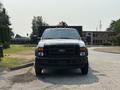 A 2009 Ford F-450 Super Duty with a white exterior and orange roof lights facing forward