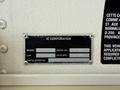 A metal identification plate displaying the model number, serial number, capacity, and manufacturing date of a 2009 International 3000 CE vehicle