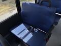 A blue upholstered seat with seatbelts in a vehicle interior designed for passenger safety
