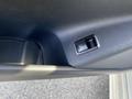 A close-up of the window control button on the door panel of a 2014 Mercedes-Benz CLA-Class. The button is black with a silver outline and features a symbol for window operation.