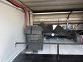 A 2017 Chevrolet Colorado truck bed with a black storage box and various equipment components including hoses and a pressure gauge